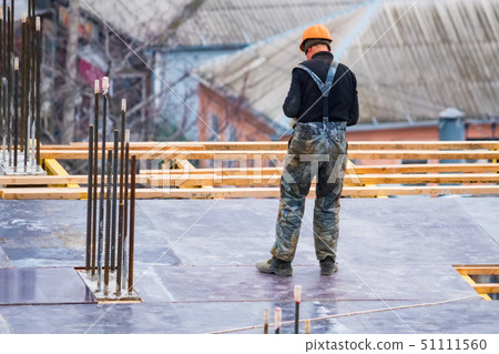 Back view construction site worker in helmet 51111560
