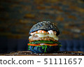 Black burger with prawns on wooden board 51111657