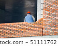 View of mason laying bricks at construction site 51111762