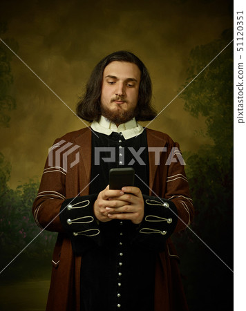 Young man as a medieval knight on dark background Young man as a medieval knight on dark background 51120351