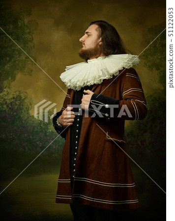 Young man as a medieval knight on dark background Young man as a medieval knight on dark background 51122053