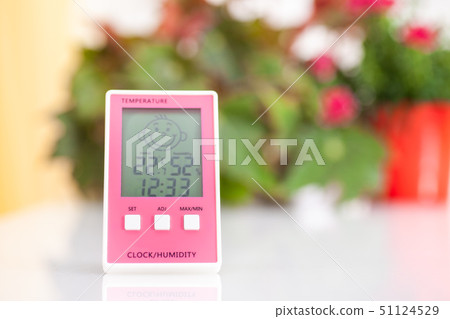 Pink hygrometer on white table 51124529