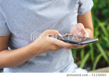 Asian girl Play smartphone For entertainment and Asian girl Play smartphone For entertainment and 51130003
