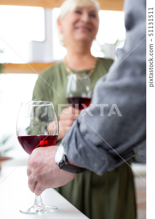 Close-up picture of male hand trying to raise a glass Close-up picture of male hand trying to raise a glass 51131511