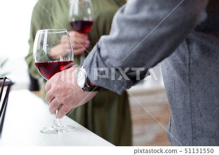 Close-up shot of male hand holding a glass. Close-up shot of male hand holding a glass. 51131550