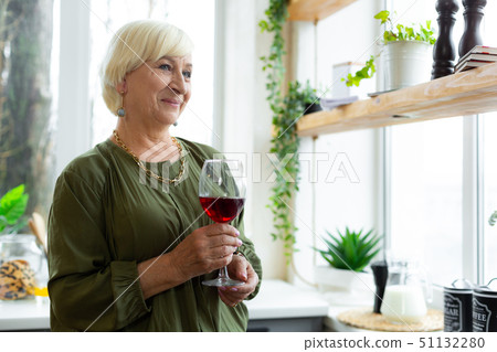 Portrait photo of woman holding a glass of red wine. Portrait photo of woman holding a glass of red wine. 51132280