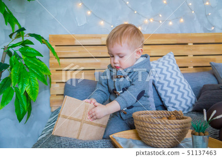 Baby boy playing with gift box Baby boy playing with gift box 51137463