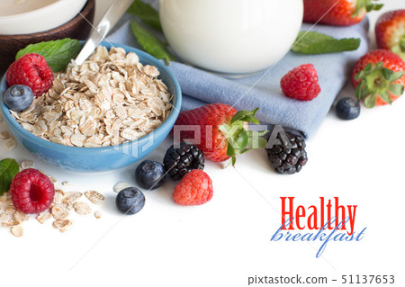 Rolled oats in a bowl with berries and milk 51137653