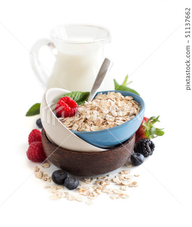 Rolled oats in a bowl with berries and milk 51137662
