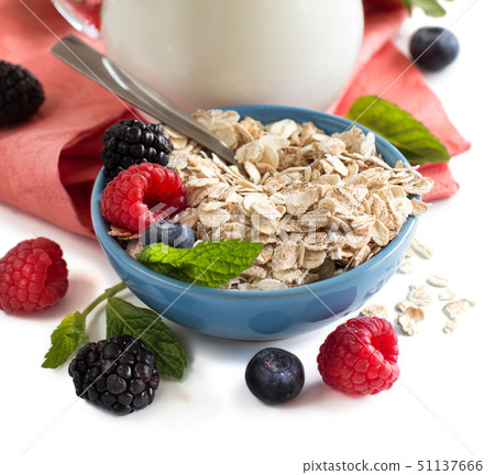 Rolled oats in a bowl with berries and milk Rolled oats in a bowl with berries and milk 51137666