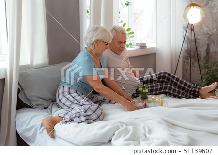 Loving spouses in pajamas having a breakfast in the bed. 51139602