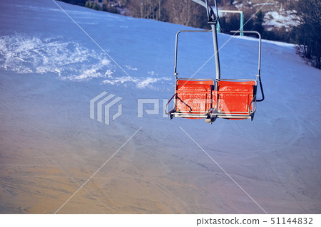 Ski lift with seats going over the mountain Ski lift with seats going over the mountain 51144832