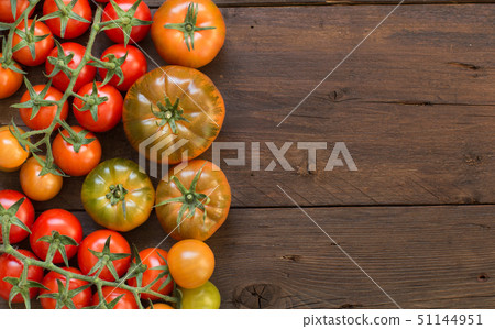 Fresh tomatoes on a wooden background Fresh tomatoes on a wooden background 51144951