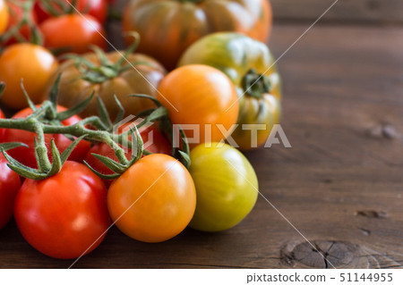 Fresh tomatoes on a wooden background Fresh tomatoes on a wooden background 51144955