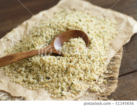 Hemp seeds with a spoon on wood Hemp seeds with a spoon on wood 51145656