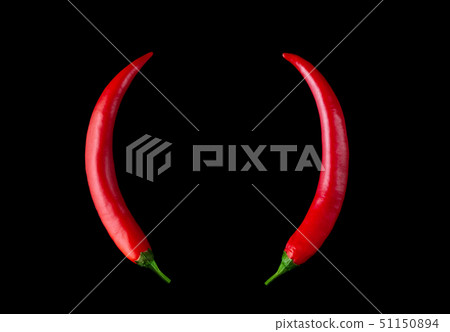 Devil horns made of red hot peppers on a black background. 51150894