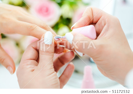 Experienced nail technician applying nail color Experienced nail technician applying nail color 51172532