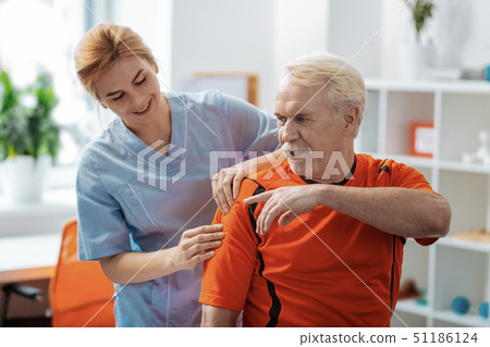 Pleasant nice aged man moving his arm Pleasant nice aged man moving his arm 51186124