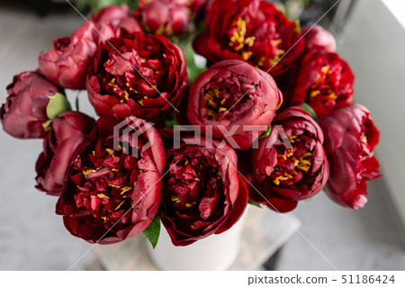 Red peonies in a metal vase. Beautiful peony flower for catalog or online store. Floral shop concept Red peonies in a metal vase. Beautiful peony flower for catalog or online store. Floral shop concept 51186424
