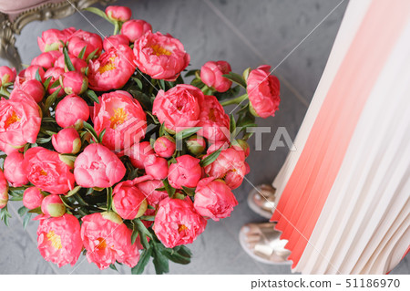 Coral peonies in a metal vase. Beautiful peony flower for catalog or online store. Floral shop Coral peonies in a metal vase. Beautiful peony flower for catalog or online store. Floral shop 51186970