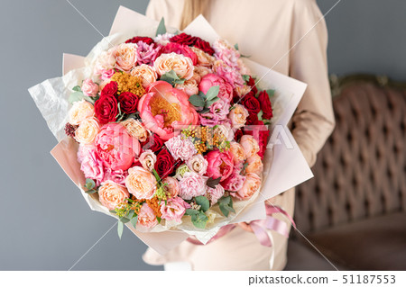 Large Beautiful bouquet of mixed flowers in woman hand. Floral shop concept . Beautiful fresh cut Large Beautiful bouquet of mixed flowers in woman hand. Floral shop concept . Beautiful fresh cut 51187553