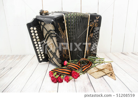 Accordion, red carnations, St. George ribbon and 51208559