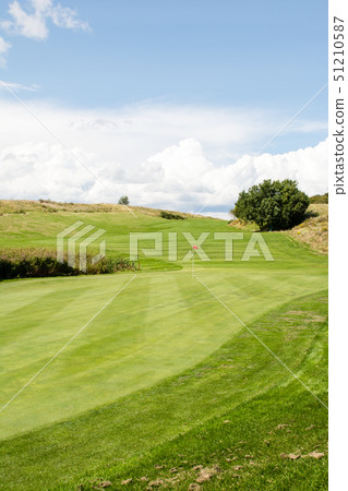 Golf course in early summer Green and fairway with red flag 51210587