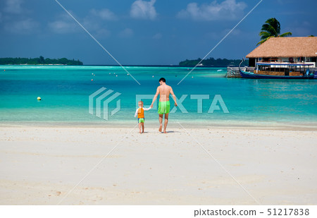 Toddler boy on beach with father 51217838