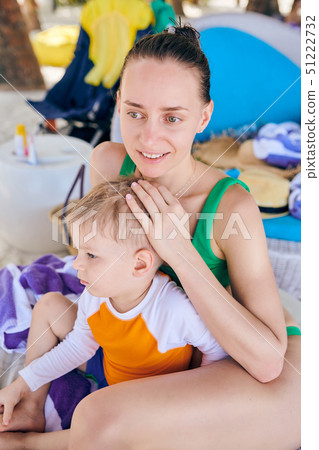Toddler boy at tropical beach with mother 51222732