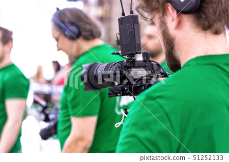 Videographer shooting a film or a television program in a studio with a professional camera 51252133