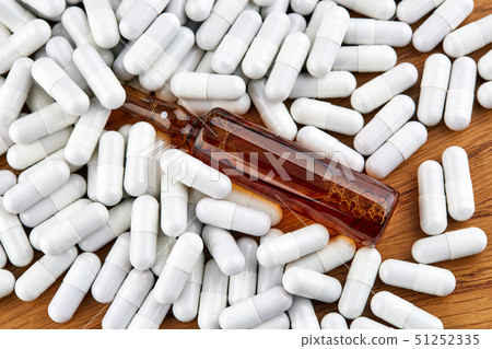 Many white pills and brown ampoule Many white pills and brown ampoule 51252335