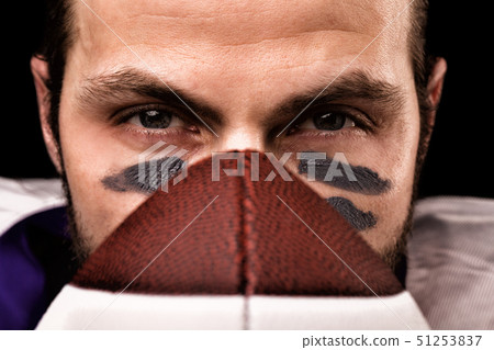 Sports concept. American football player on black with ball. Sports concept. close-up Sports concept. American football player on black with ball. Sports concept. close-up 51253837