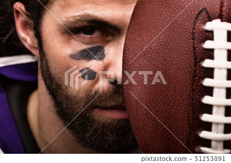 Sports concept. American football player on black with ball. Sports concept. close-up Sports concept. American football player on black with ball. Sports concept. close-up 51253891