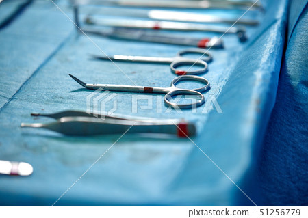 Close up of doctor hands during surgery in operation room. Sterile surgery instruments used in a 51256779