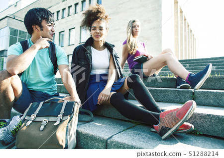 cute group of teenages at the building of university with books huggings, diversity nations real cute group of teenages at the building of university with books huggings, diversity nations real 51288214
