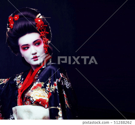 young pretty real geisha in kimono with sakura and decoration on black background young pretty real geisha in kimono with sakura and decoration on black background 51288262