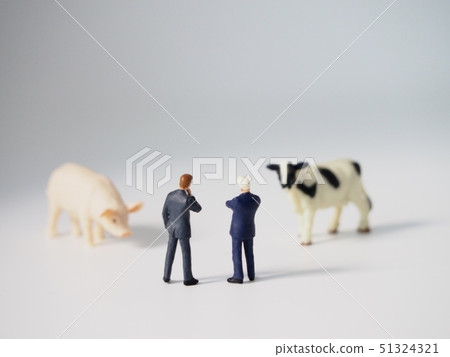 Businessman looking at a cow and a pig 51324321