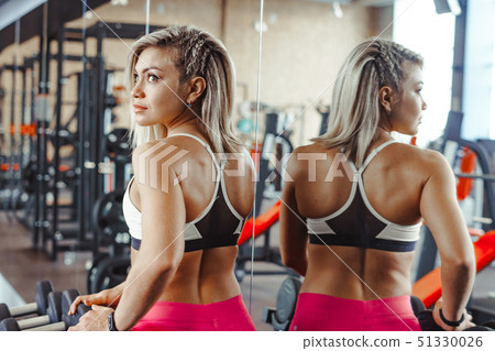 girl in the gym dumbbells 51330026