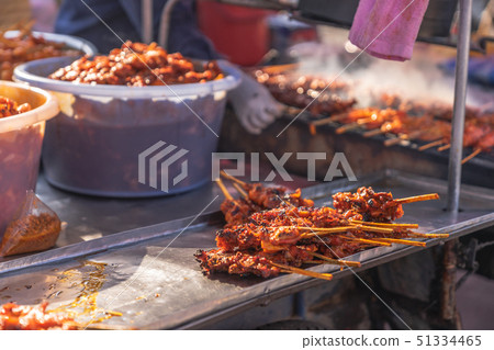 grilled chicken skewer on charcoal food stall, 51334465