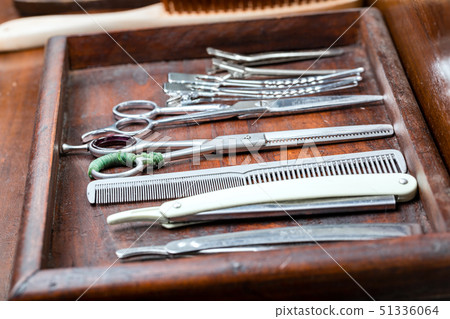 Professional barber trimming the client's hair 51336064