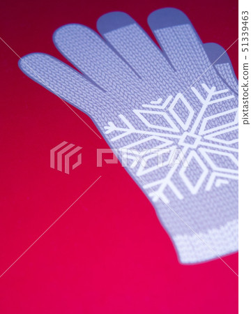 Image of grey winter glove on red background 51339463