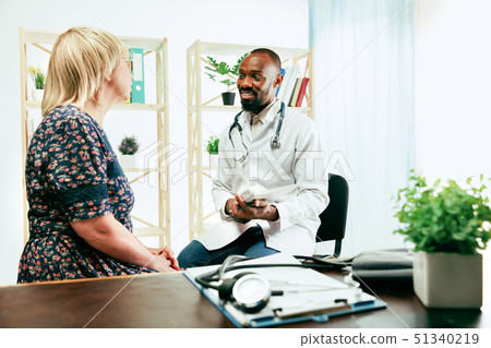 A senior woman visiting a therapist at the clinic A senior woman visiting a therapist at the clinic 51340219