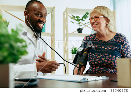 A senior woman visiting a therapist at the clinic 51340378