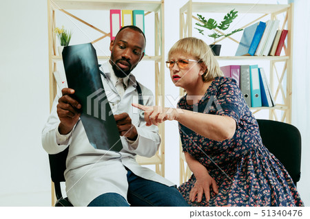 A senior woman visiting a therapist at the clinic A senior woman visiting a therapist at the clinic 51340476