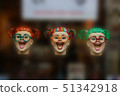 Three colourful fake laughing woman heads floating 51342918