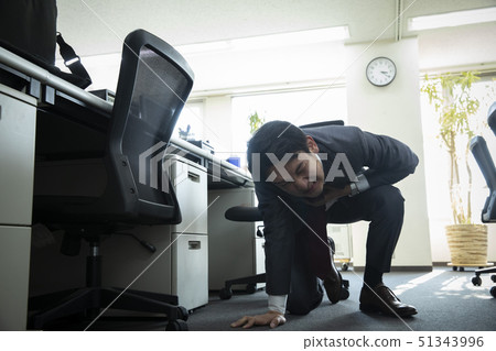 Businessman falling down at work 51343996
