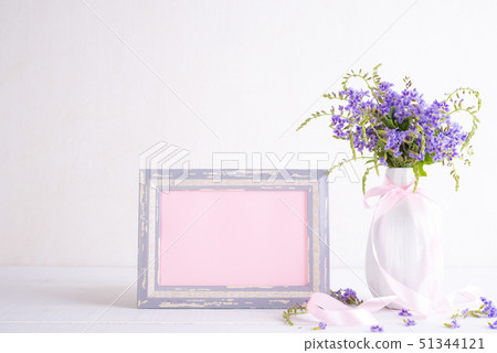 White picture frame with lovely purple flower White picture frame with lovely purple flower 51344121
