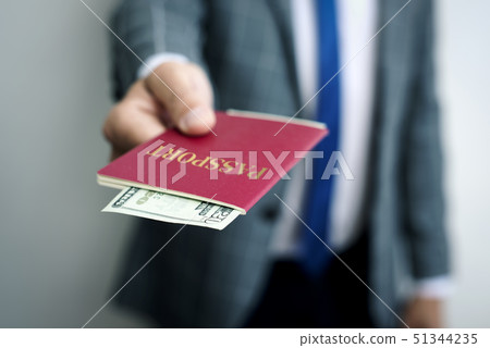 businessman with 20 dollars in his passport businessman with 20 dollars in his passport 51344235