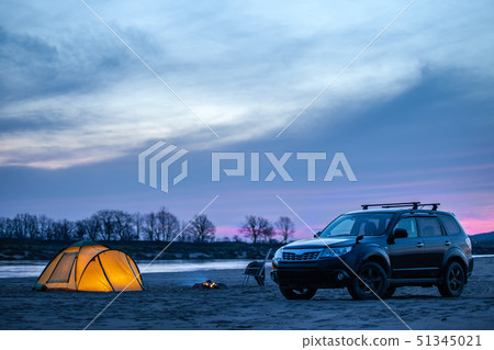 Camping at sunrise on a sand river bank 51345021