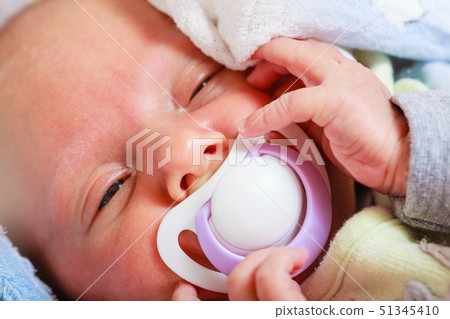 Closeup of little newborn sleeping with teat in Closeup of little newborn sleeping with teat in 51345410